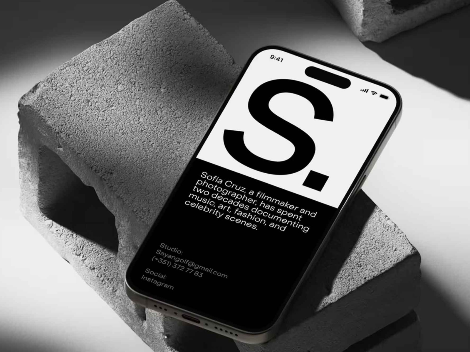 Free iPhone 15 On Concrete Block PSD Mockup